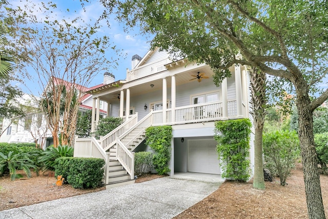 view of front of property with ceiling fan, covered porch, and a garage