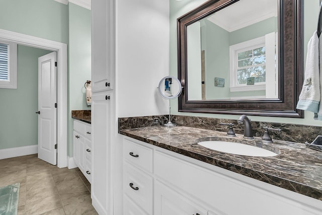 bathroom with tile patterned flooring, vanity, and crown molding