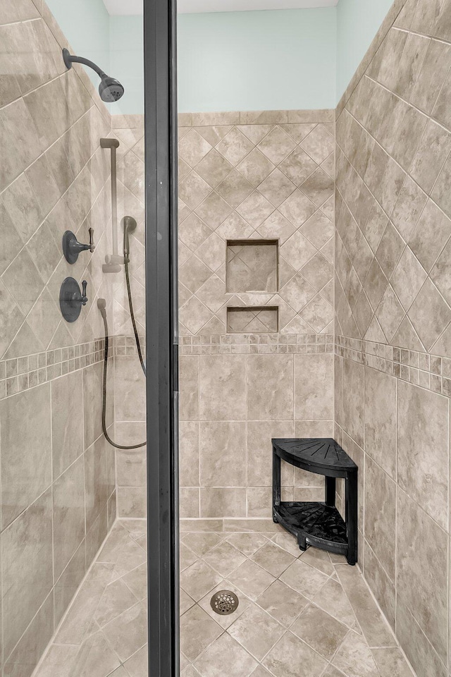 bathroom with tiled shower