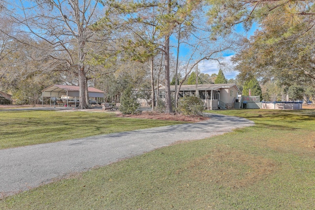 view of front of home with a front lawn and a carport