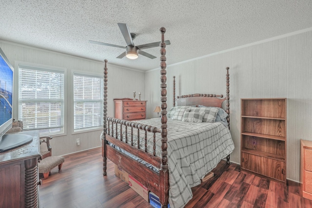 bedroom featuring ceiling fan, dark hardwood / wood-style floors, and a textured ceiling