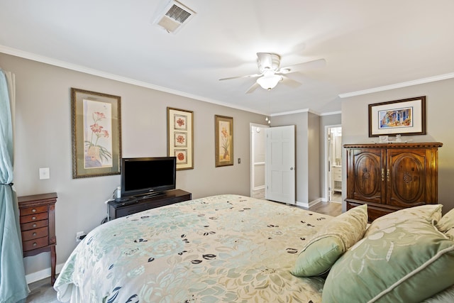 bedroom featuring visible vents, ceiling fan, baseboards, ornamental molding, and ensuite bath