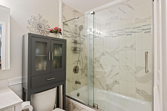 full bathroom with combined bath / shower with glass door, toilet, vanity, and ornamental molding