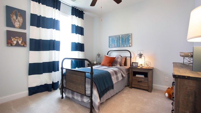 bedroom with ceiling fan and light colored carpet