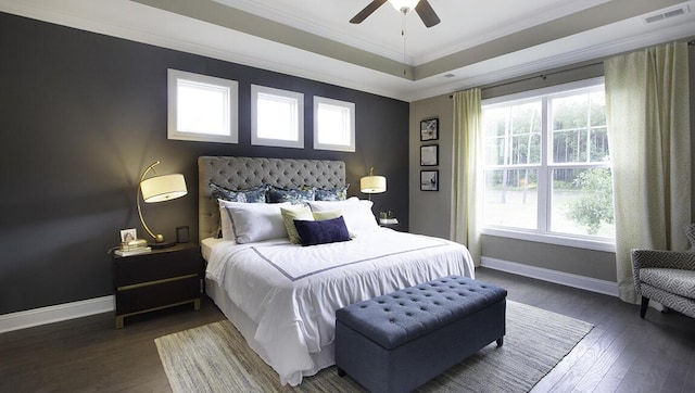 bedroom with ceiling fan, multiple windows, dark hardwood / wood-style flooring, and crown molding