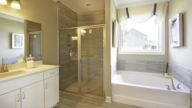 bathroom featuring vanity and separate shower and tub