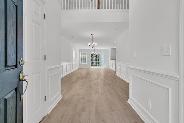 4823 Shady Tree Ln, Summerville, SC 29485 - foyer with a chandelier, a decorative wall, light wood-style flooring, and wainscoting