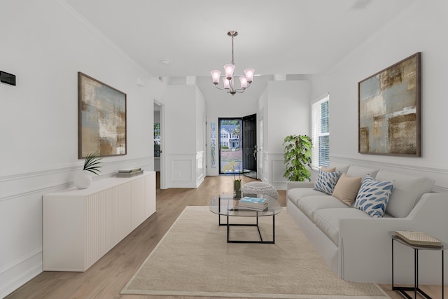 4823 Shady Tree Ln, Summerville, SC 29485 - living area with a decorative wall, a chandelier, light wood-style flooring, and a wainscoted wall