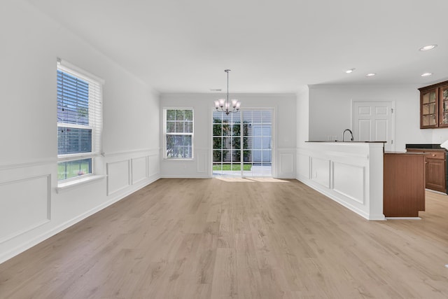 4823 Shady Tree Ln, Summerville, SC 29485 - unfurnished dining area with a decorative wall, a chandelier, light wood finished floors, recessed lighting, and wainscoting