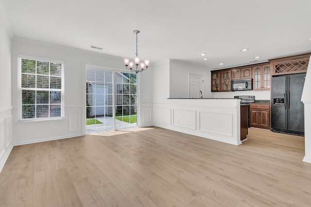 4823 Shady Tree Ln, Summerville, SC 29485 - kitchen featuring black appliances, a decorative wall, a chandelier, crown molding, and glass insert cabinets