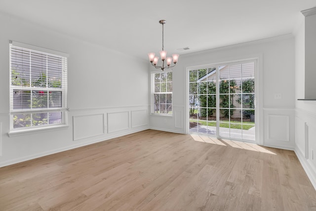 4823 Shady Tree Ln, Summerville, SC 29485 - unfurnished dining area featuring a chandelier, a decorative wall, crown molding, a wainscoted wall, and light wood-style floors