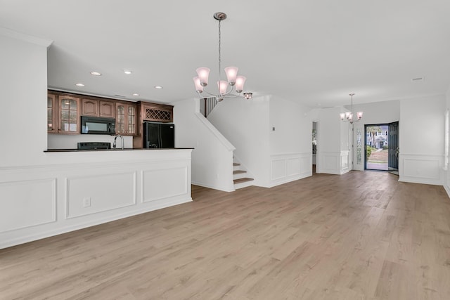 4823 Shady Tree Ln, Summerville, SC 29485 - unfurnished living room featuring a chandelier, a decorative wall, recessed lighting, a wainscoted wall, and light wood finished floors
