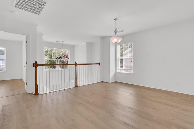 4823 Shady Tree Ln, Summerville, SC 29485 - unfurnished room featuring plenty of natural light, wood finished floors, a chandelier, and baseboards