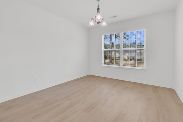 4823 Shady Tree Ln, Summerville, SC 29485 - spare room featuring light wood-style floors, baseboards, and a chandelier