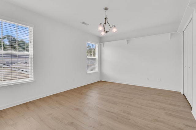 4823 Shady Tree Ln, Summerville, SC 29485 - unfurnished room featuring light wood-type flooring, a chandelier, and baseboards