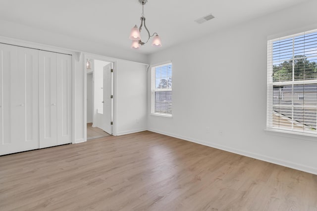 4823 Shady Tree Ln, Summerville, SC 29485 - unfurnished bedroom with multiple windows, light wood-style floors, and baseboards