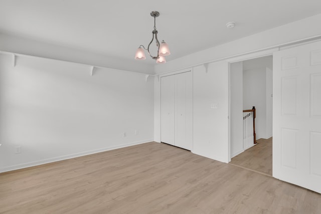 4823 Shady Tree Ln, Summerville, SC 29485 - unfurnished bedroom with light wood-style flooring, a closet, baseboards, and a chandelier