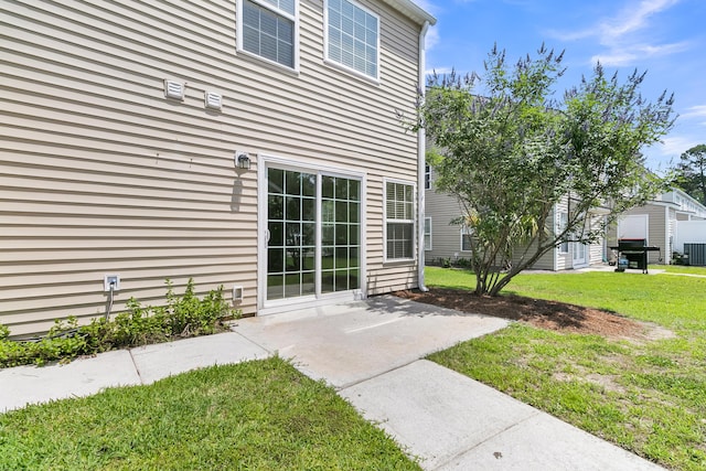 4823 Shady Tree Ln, Summerville, SC 29485 - view of exterior entry with a yard, central air condition unit, and a patio