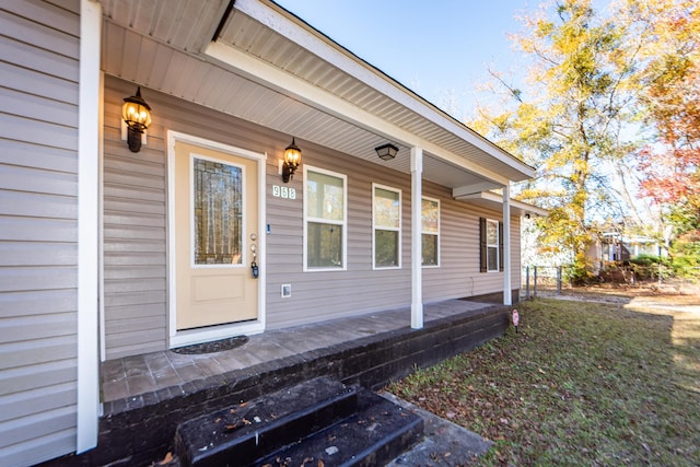 view of exterior entry featuring covered porch