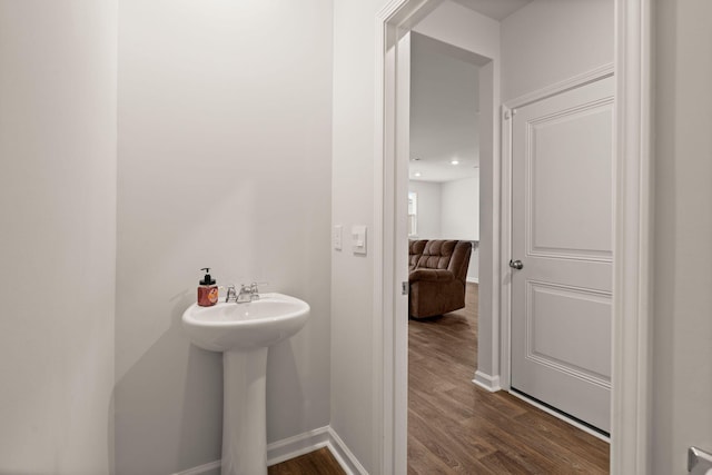 bathroom with hardwood / wood-style flooring and sink