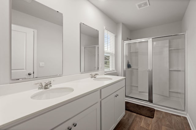 bathroom featuring vanity, a shower with shower door, and hardwood / wood-style flooring