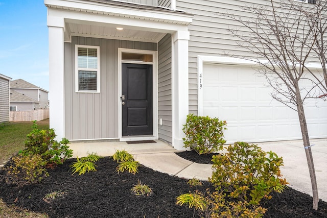 doorway to property with a garage