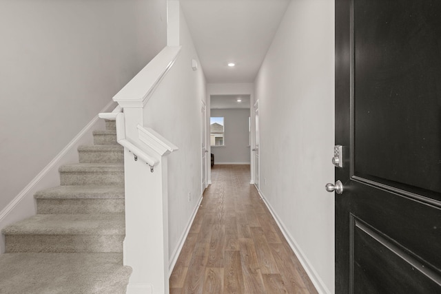 stairway with hardwood / wood-style flooring