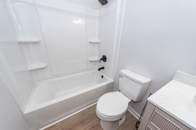 full bathroom with hardwood / wood-style floors, vanity, bathtub / shower combination, and toilet