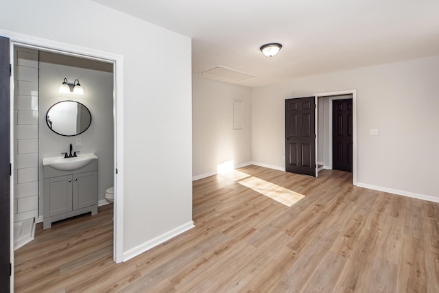 interior space with sink and light hardwood / wood-style flooring