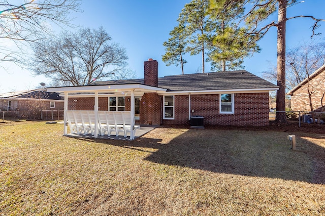 back of house featuring a lawn, cooling unit, and a patio area