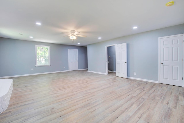 empty room with light hardwood / wood-style floors and ceiling fan