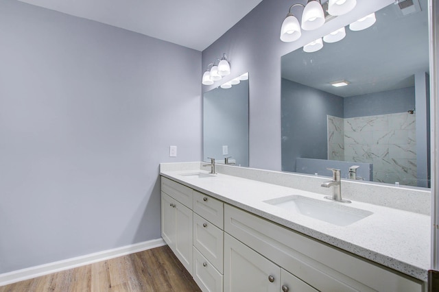 bathroom featuring double sink, hardwood / wood-style floors, and large vanity