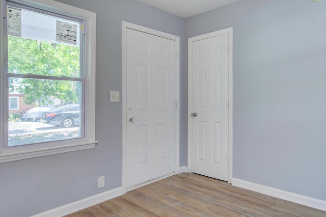 unfurnished room with a wealth of natural light and light hardwood / wood-style floors