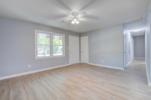 spare room featuring ceiling fan and light hardwood / wood-style floors