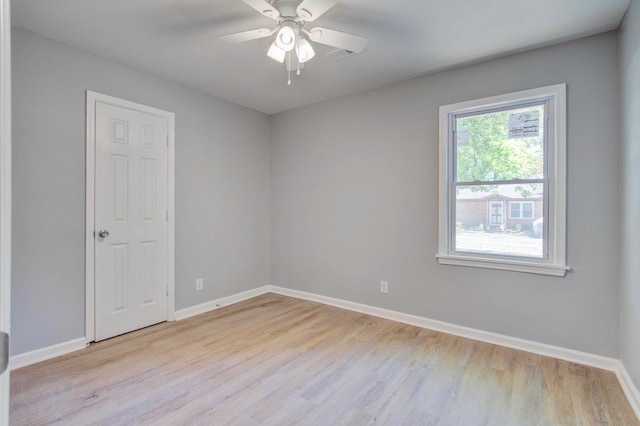 spare room featuring light hardwood / wood-style flooring and ceiling fan