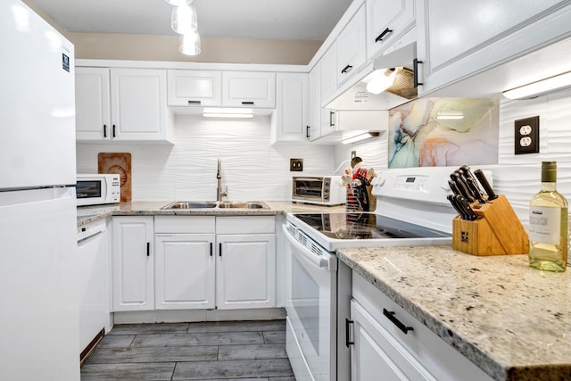 kitchen with white cabinetry, white appliances, sink, and tasteful backsplash