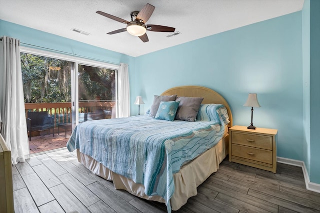 bedroom featuring ceiling fan, a textured ceiling, access to outside, and wood-type flooring