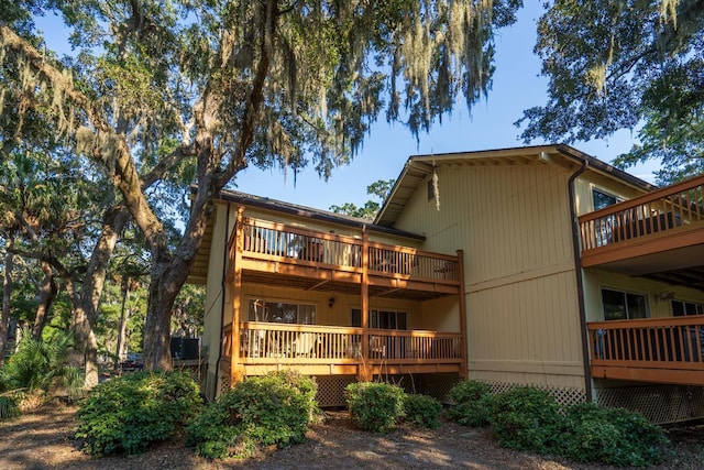 back of property featuring a deck and a balcony