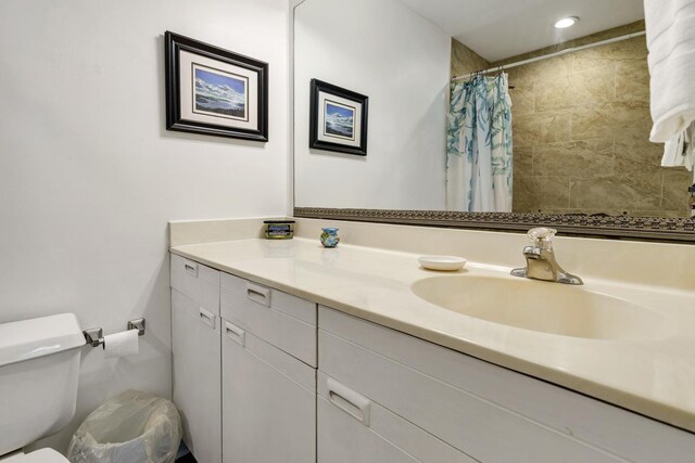 bathroom with vanity, walk in shower, and toilet