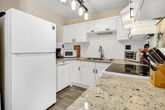 kitchen featuring light wood-type flooring, tasteful backsplash, white cabinets, white appliances, and sink