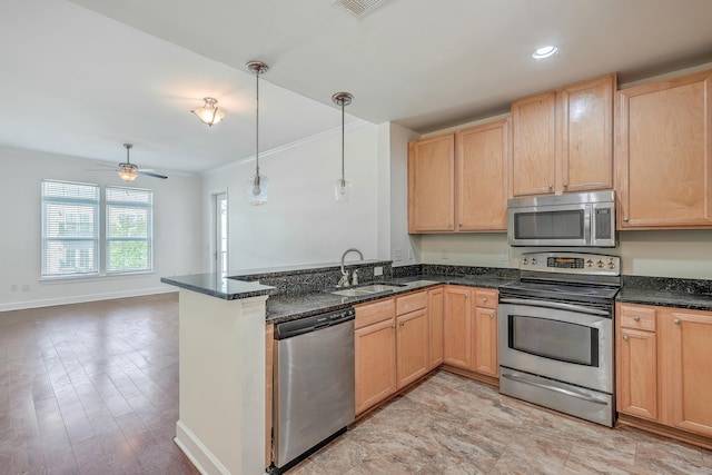 kitchen featuring sink, hanging light fixtures, stainless steel appliances, kitchen peninsula, and dark stone counters