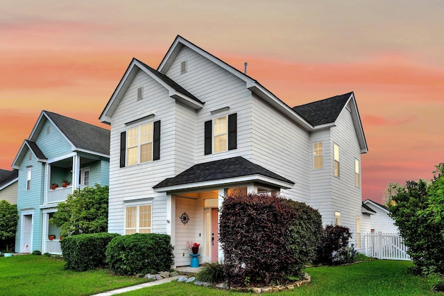traditional-style home with a shingled roof