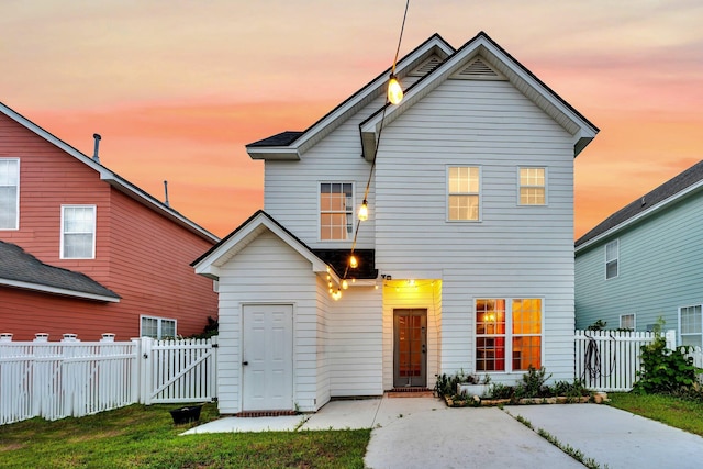 traditional home featuring a gate and a fenced backyard