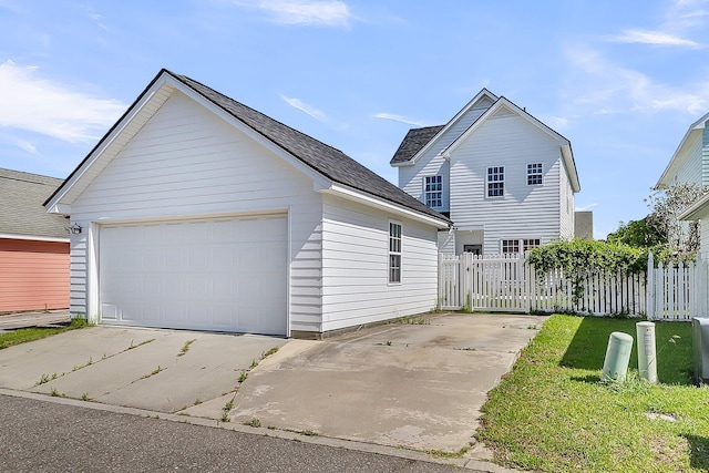 traditional-style house with an outbuilding, fence, and a detached garage