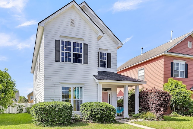 traditional home with a shingled roof