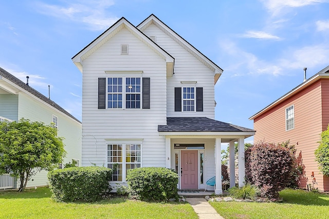 traditional-style home featuring roof with shingles