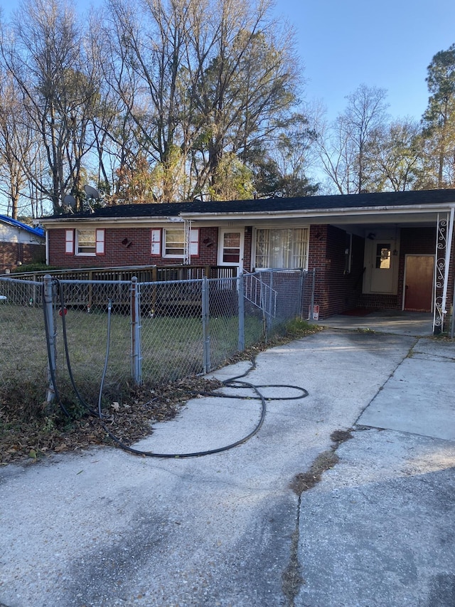 rear view of property with a lawn and a carport