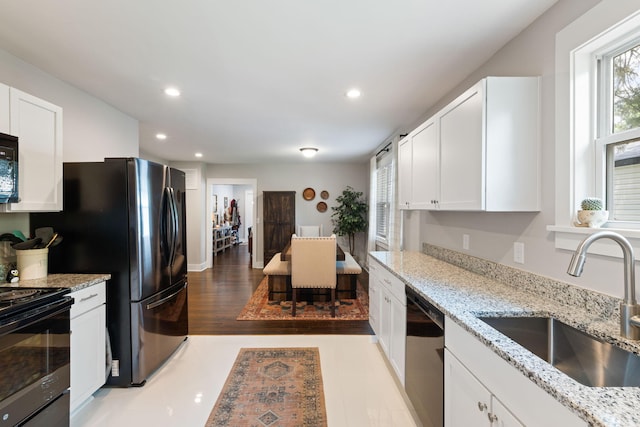 2924 Alabama Dr, North Charleston, SC 29405 - kitchen featuring a sink, black appliances, white cabinetry, recessed lighting, and light stone countertops
