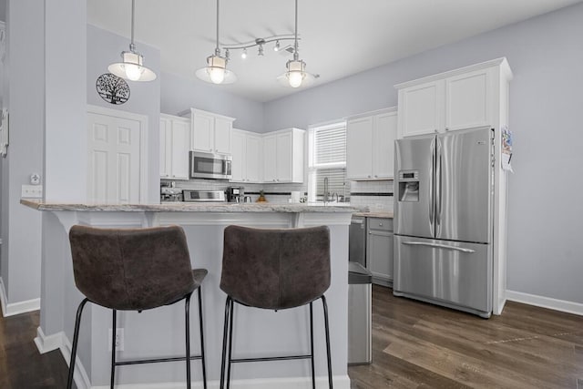 185 Red Leaf Blvd, Moncks Corner, SC 29461 - kitchen featuring stainless steel appliances, decorative backsplash, baseboards, dark wood-style flooring, and white cabinetry