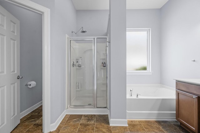 185 Red Leaf Blvd, Moncks Corner, SC 29461 - full bath featuring a stall shower, vanity, a garden tub, baseboards, and stone finish floors